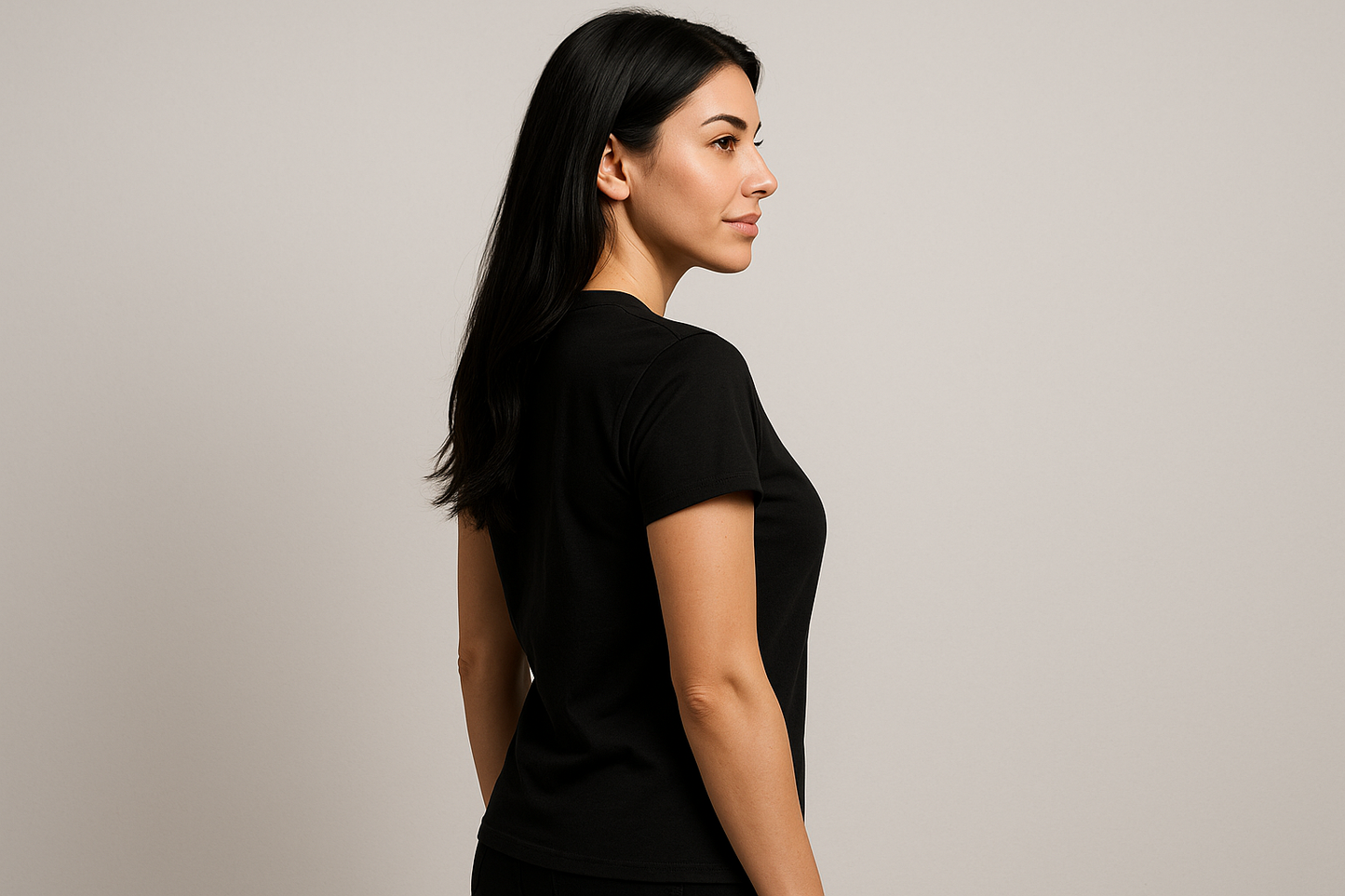 a lady with black long hair wearing a black tshirt is posing to show the side of the tshirt