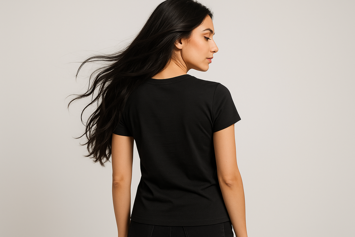 a lady with long black hair wearing a black tshirt and posing to show the back side